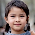 Asian girl portrait. A child face with a cute, confident expression