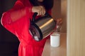 Asian girl pour hot water into a white cup Royalty Free Stock Photo