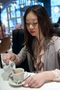 Asian girl pours cream