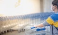 The asian girl pushing the trolley cart shopping the decorate funiture for interior inside the house in the big warehouse store