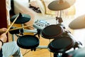 Asian girl put black tshirt and headphone learning and play electronic drum wooden drumsticks Royalty Free Stock Photo