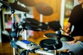 Asian girl put black tshirt and headphone learning and play electronic drum wooden drumsticks Royalty Free Stock Photo