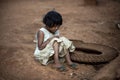 Asian girl A ragged dress sitting on the ground at a rural village. Bowing and crying, child being teased and bullied