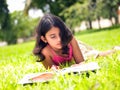 Asian girl reading a book in the park Royalty Free Stock Photo