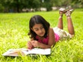 Asian girl reading a book in the park Royalty Free Stock Photo