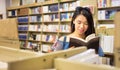 Asian girl reading in a bookstore Royalty Free Stock Photo