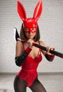 asian girl in a red rabbit mask and sexy red bodysuit with an axe in the image of a superhero Royalty Free Stock Photo