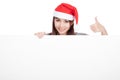 Asian girl with red santa hat show thumbs up with a blank sign Royalty Free Stock Photo