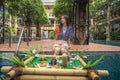 Asian girl relax on the swimming pool in hotel and eating with floting tray Royalty Free Stock Photo