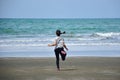 Asian girl is running on the beach into the sea