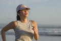 Asian girl running on the beach - young attractive and happy Korean woman doing jogging workout at beautiful beach enjoying Royalty Free Stock Photo