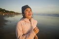 Asian girl running on the beach - young attractive and happy Korean woman doing jogging workout at beautiful beach enjoying Royalty Free Stock Photo