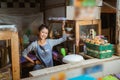 Asian girl selling standing leisurely with one hand on waist