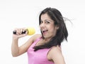 Asian girl singing into her mike Royalty Free Stock Photo