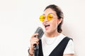 Girl sings into the microphone. The concept of vocal school and karaoke entertainment