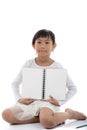 Asian girl sitting and holding blank notebook Royalty Free Stock Photo