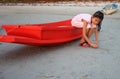 Asian girl sitting on the little red boat. Royalty Free Stock Photo