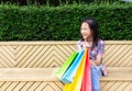 Asian girl sitting outdoor with shopping bags Royalty Free Stock Photo