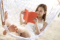 Asian girl sleep and reading on the beach thid image can use for travel, summer Royalty Free Stock Photo