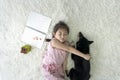 An Asian girl is sleeping hugging a Shiba Inu on the carpet in the living room
