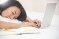 Asian girl sleeping with laptop on her bed. Royalty Free Stock Photo