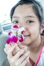 Asian girl smelling orchid flower Royalty Free Stock Photo