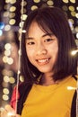 Asian girl smileing with bokeh light in christmas day, selective focus Royalty Free Stock Photo