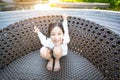 Asian girl smiling happily sitting on a big chair by the pool on holiday Royalty Free Stock Photo