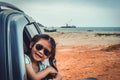 Asian girl smiling while sitting in the car. Travel on vacation Royalty Free Stock Photo