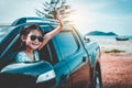 Asian girl smiling while sitting in the car. Travel on vacation Royalty Free Stock Photo