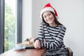 Asian girl smiling sitting in coffee shop,Woman wearing Santa Cl Royalty Free Stock Photo