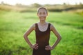 Asian girl in sportswear running across field, morning workout