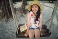 Asian girl with straw hat smiling and having fun on holiday Royalty Free Stock Photo