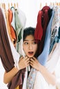 Asian girl stuck in her mess of clothes