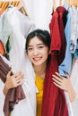 Asian girl stuck in her mess of clothes