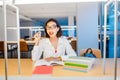 Asian girl student doing homework in library Royalty Free Stock Photo