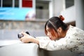 Asian girl student learn photography with small pocket camera outdoor at day Royalty Free Stock Photo