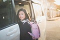 Asian girl in student uniform going to school by car Royalty Free Stock Photo