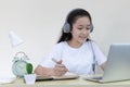 Asian girl is studying online via the internet with a cheerful smile Royalty Free Stock Photo