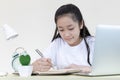 Asian girl is studying online via the internet with a cheerful smile Royalty Free Stock Photo