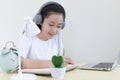 Asian girl is studying online via the internet with a cheerful smile, stay home, New normal Royalty Free Stock Photo