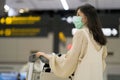 Asian girl with surgical mask in airport, New normal lifestyle, Covid-19 crisis, travel bubble
