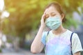 Asian girl with surgical mask felling dizziness Royalty Free Stock Photo