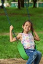 Asian girl swinging and smiling