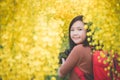 Asian girl take photo with blooming yellow flower Royalty Free Stock Photo