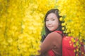 Asian girl take photo with blooming yellow flower Royalty Free Stock Photo