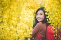 Asian girl take photo with blooming yellow flower Royalty Free Stock Photo