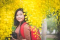 Asian girl take photo with blooming yellow flower Royalty Free Stock Photo