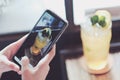 Asian girl taking drinks photo by  her smartphone camera Royalty Free Stock Photo