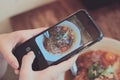 Asian girl taking food photo by  her smartphone camera Royalty Free Stock Photo
